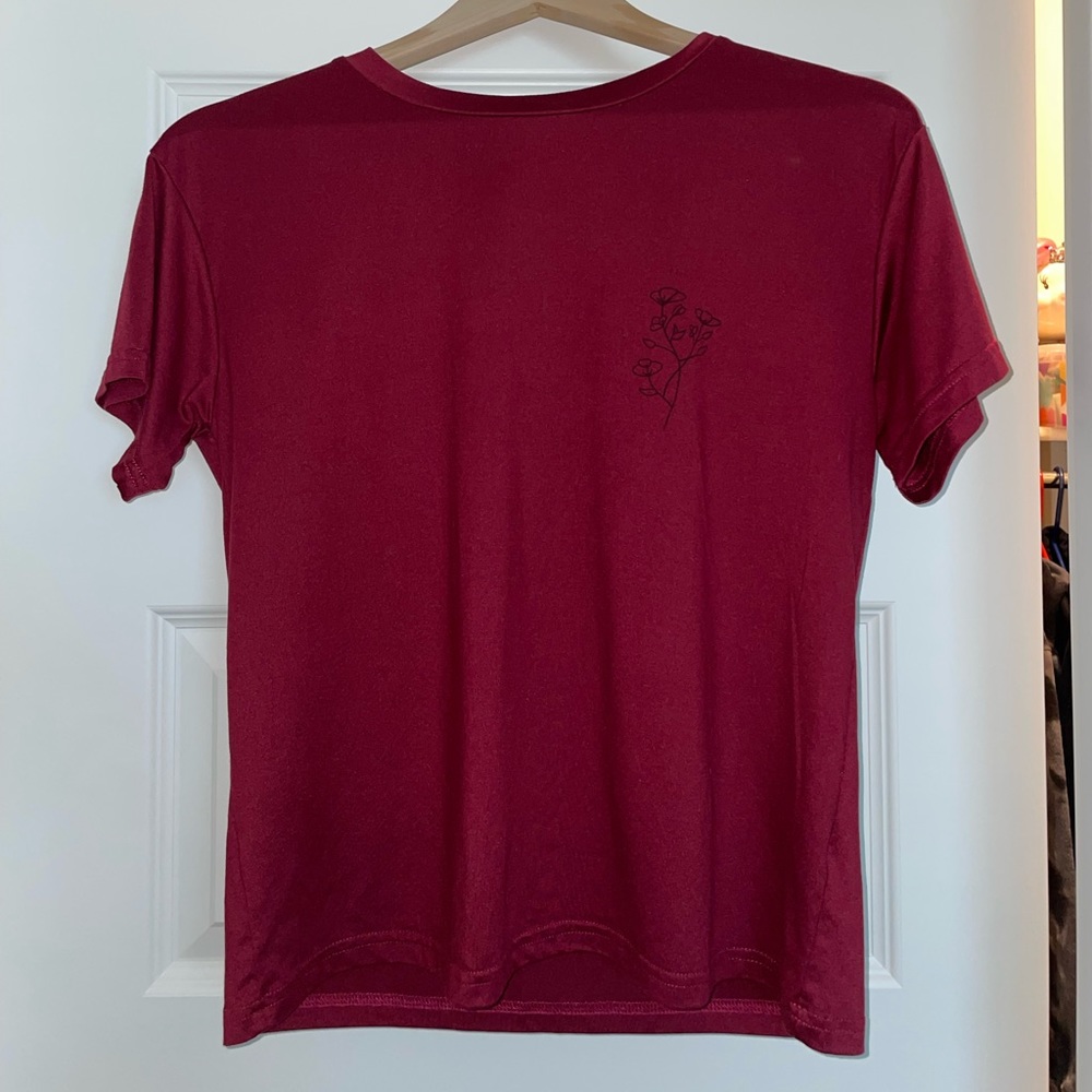 Red short sleeved tshirt with black outlined flowers